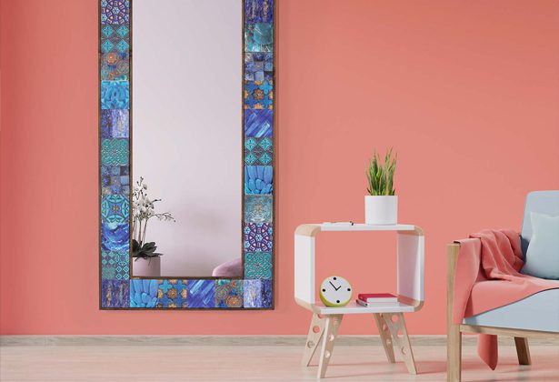 A mirror with blue tiles on the wall