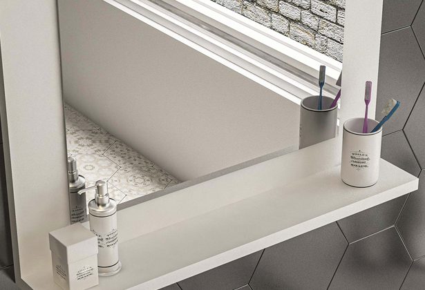 A bathroom with a large mirror and counter top.
