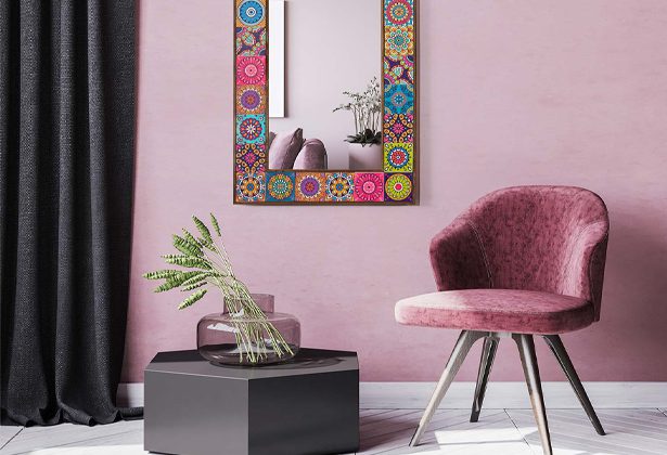 A pink room with a mirror and chair
