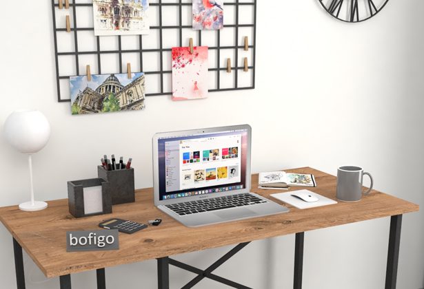 A laptop sitting on top of a wooden desk.