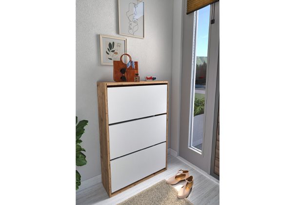 A white shoe cabinet in the corner of a room.