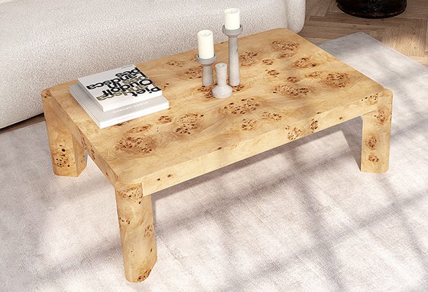 A coffee table with candles and books on it
